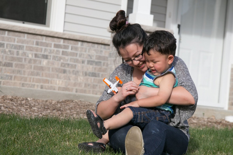 A Habitat homeowner with her son.